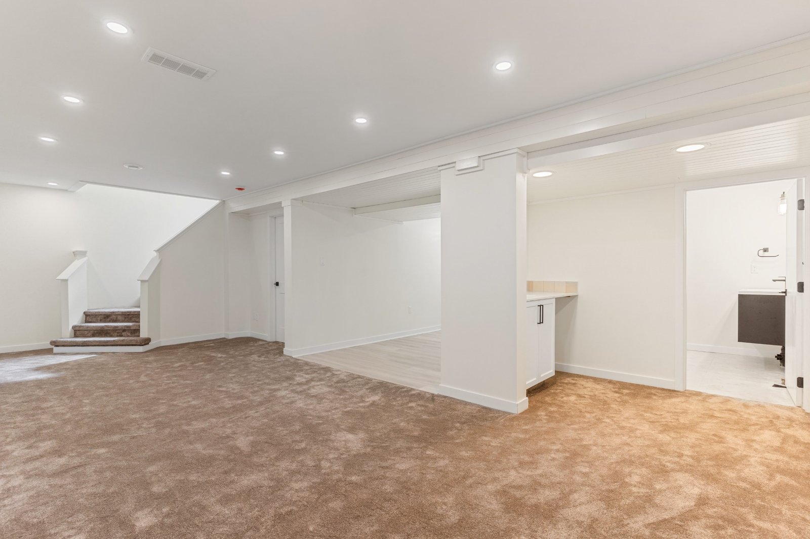Finished WestForge basement with recessed lighting and open living space